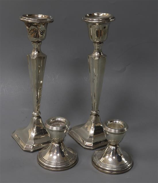 A pair of George V silver candlesticks and a pair of later silver dwarf candlesticks, tallest 20.2cm.
